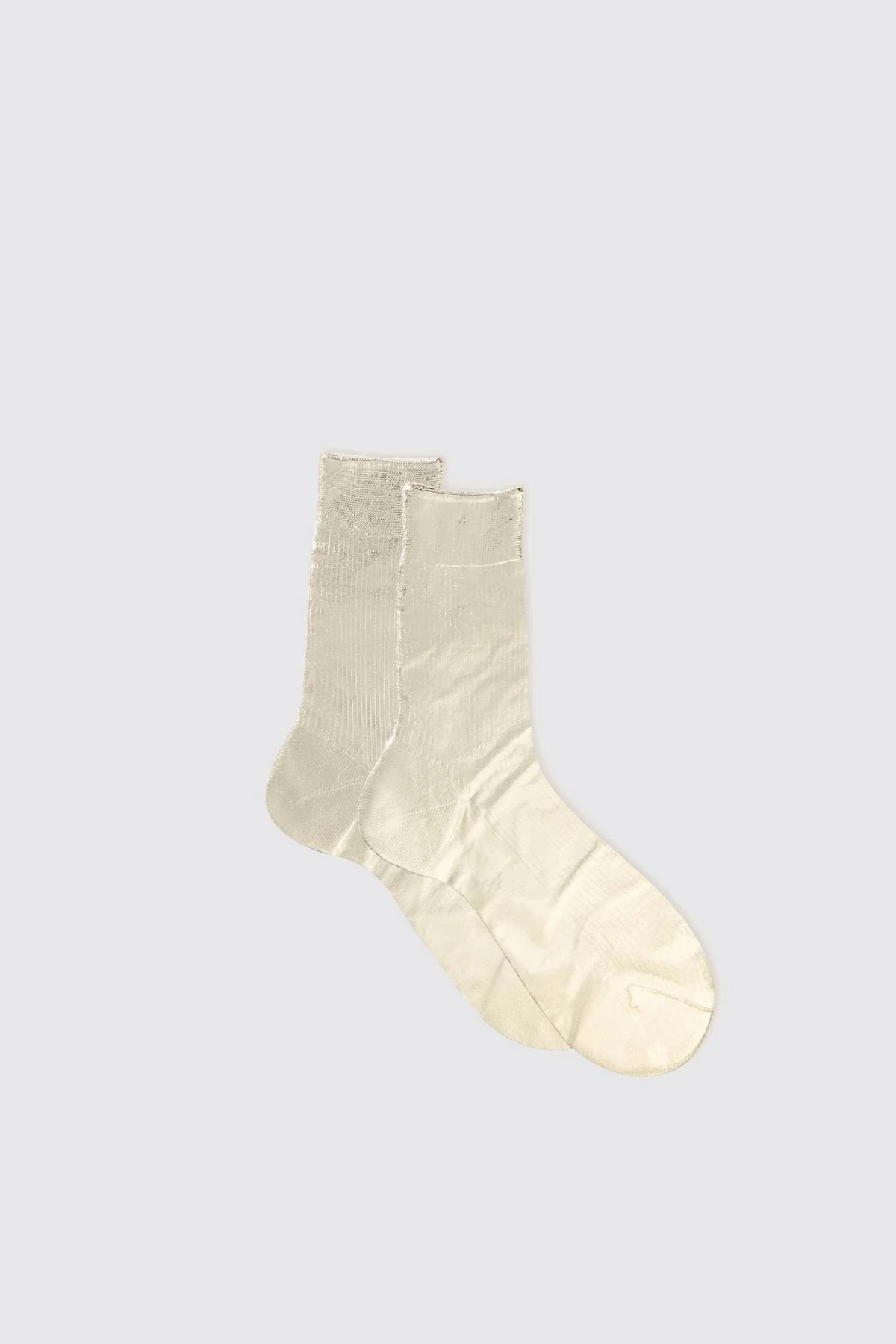Pair of beige socks on a light gray background