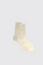 Pair of beige socks on a light gray background