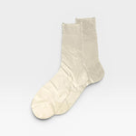 Pair of beige socks on a light gray background