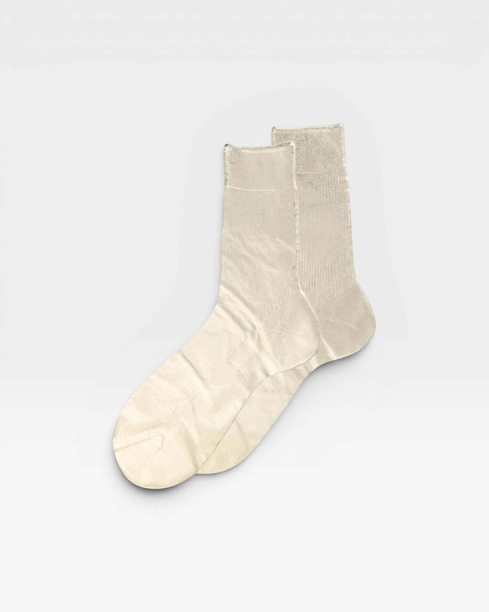 Pair of beige socks on a light gray background