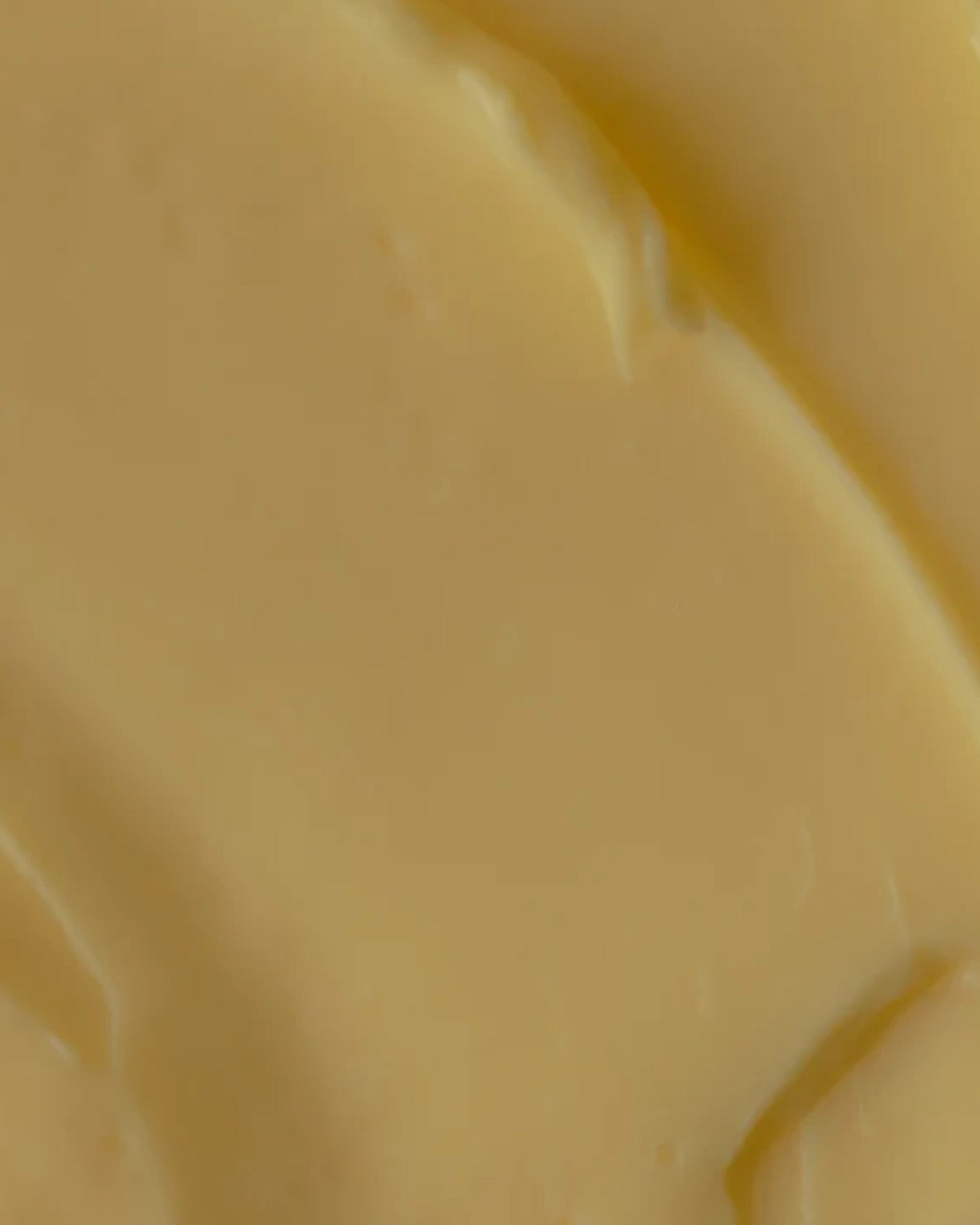 Close-up of smooth, creamy yellow body butter by Oak Essentials