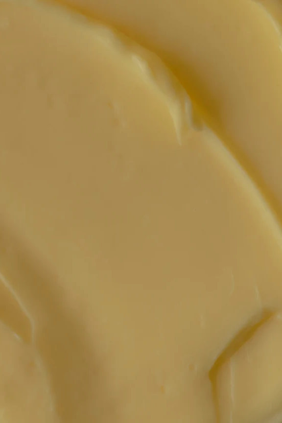 Close-up of smooth, creamy yellow body butter by Oak Essentials