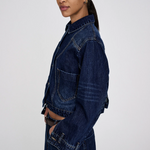 Woman wearing a long denim jacket on a white background