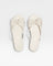 Pair of white sandals with bow details on a white background