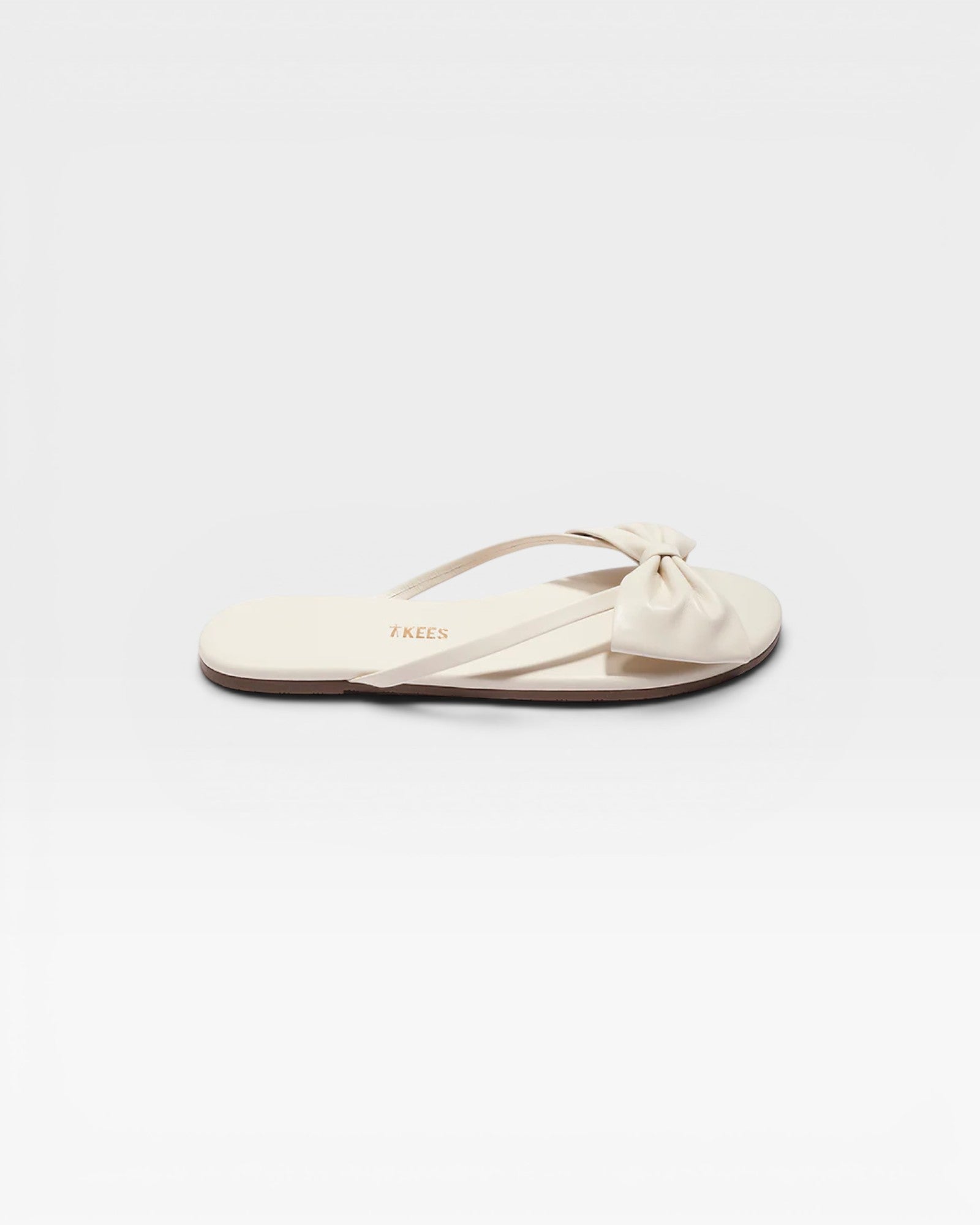 Beige sandal with a bow on a white background
