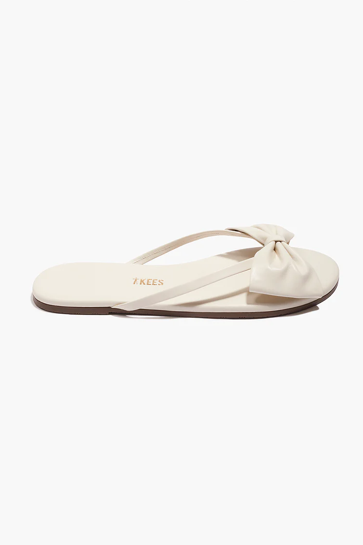 Beige sandal with a bow on a white background