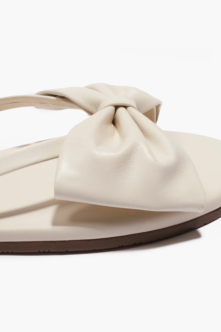 Beige sandal with a bow on a white background