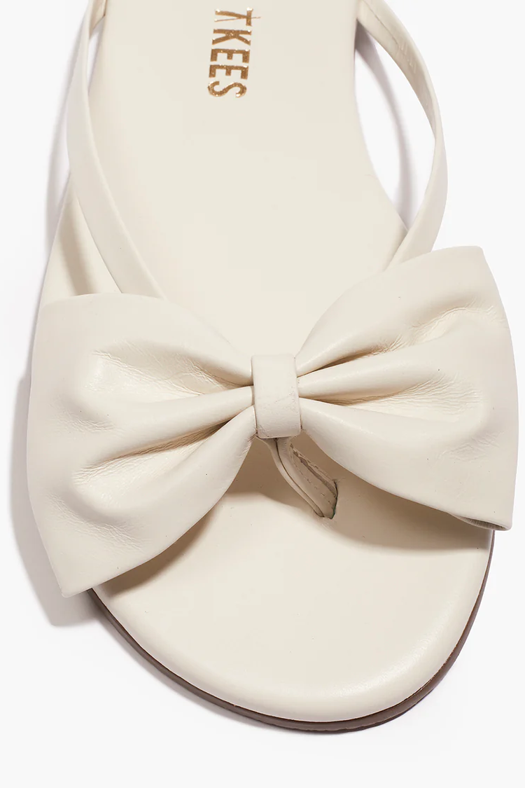 White sandal with a large bow on a white background
