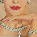Vintage advertisement for Trifari jewelry featuring a woman wearing a necklace and earrings.