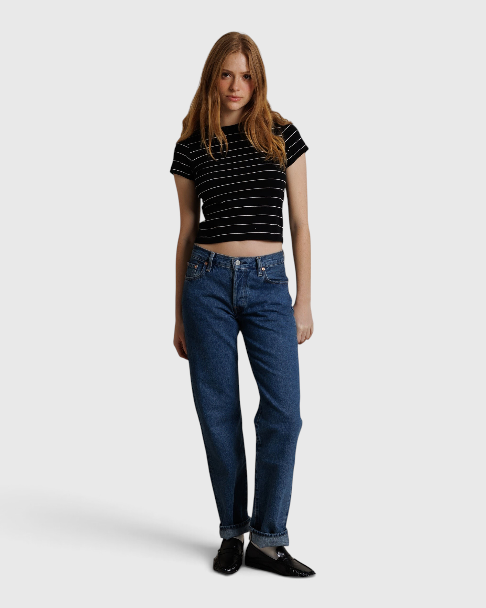 JONES + CO Lisa Tee in black with white stripes, made from recycled cotton, worn by a model with blue jeans.