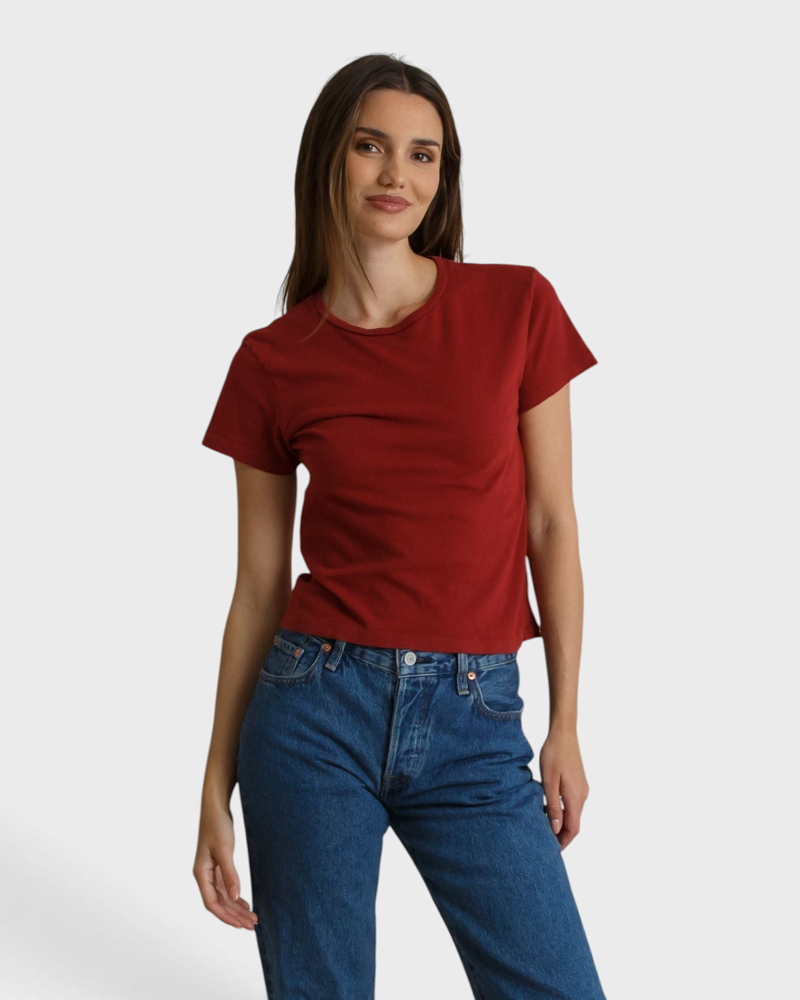 Model wearing a JONES + CO ruby red slim fit crew neck t-shirt made from recycled cotton with blue denim jeans
