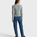 Back view of a woman wearing a JONES + CO griffin grey recycled cotton long sleeve top with blue jeans