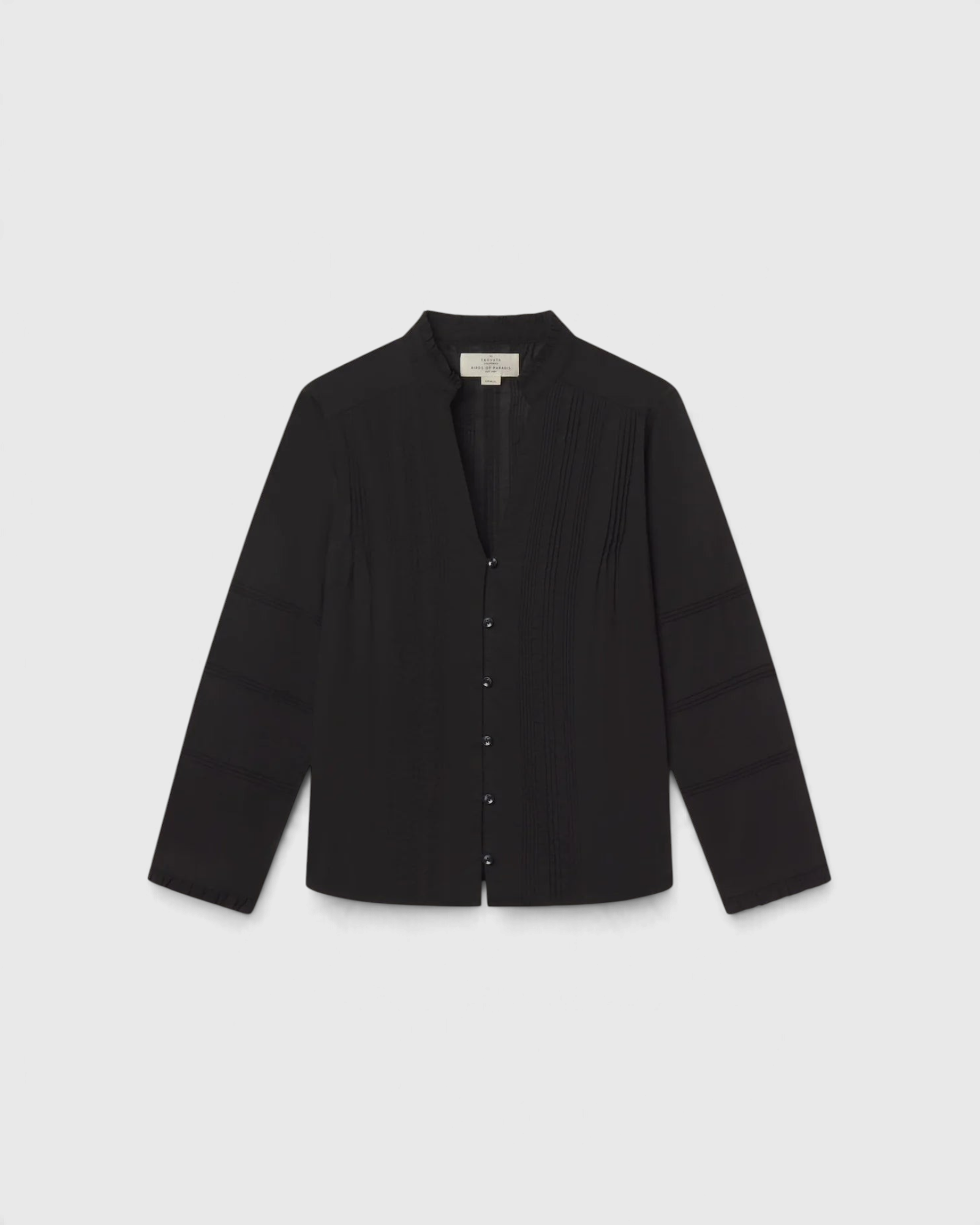 JONES + CO Maris black blouse featuring pintuck details, a ruffled stand collar, and long sleeves.