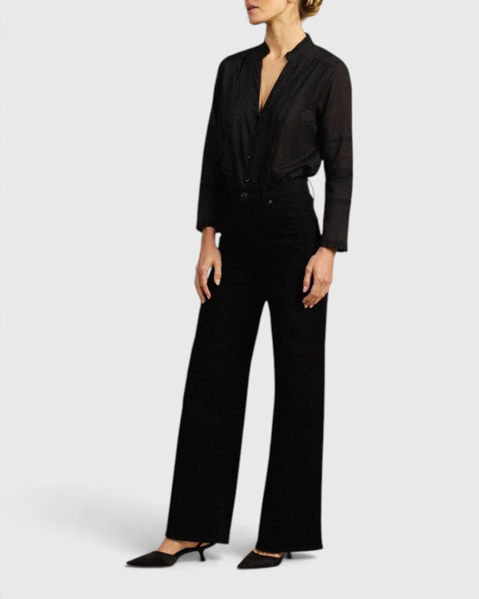 JONES + CO Maris black blouse with pintuck details, ruffled stand collar, and long sleeves on a model.