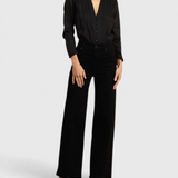 JONES + CO black Maris blouse with pintuck details, ruffled stand collar, and long sleeves on a model.