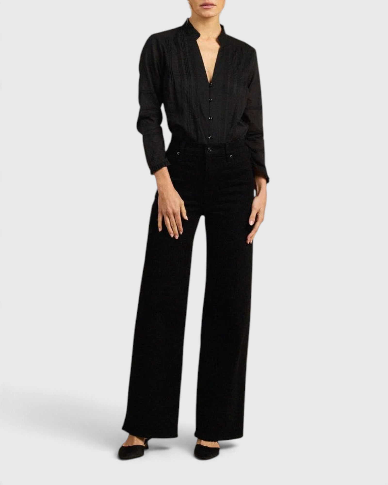 JONES + CO black Maris blouse with pintuck details, ruffled stand collar, and long sleeves on a model.