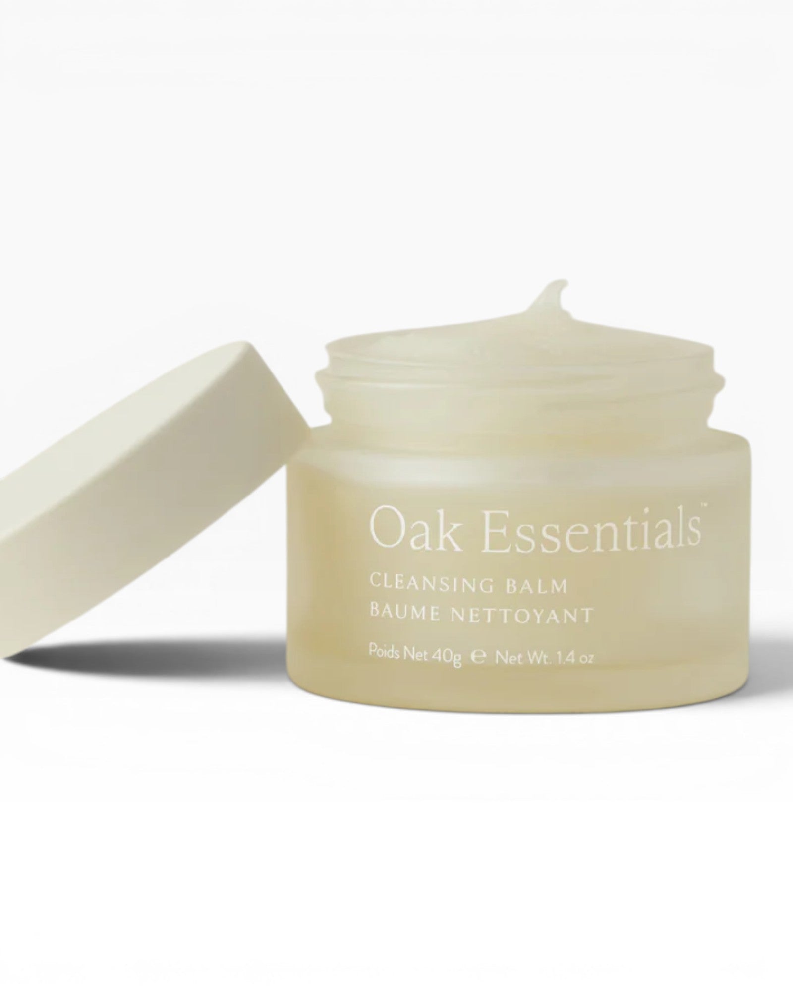 Cleansing balm jar with lid on a light beige background, featuring 'Oak Essentials' branding.