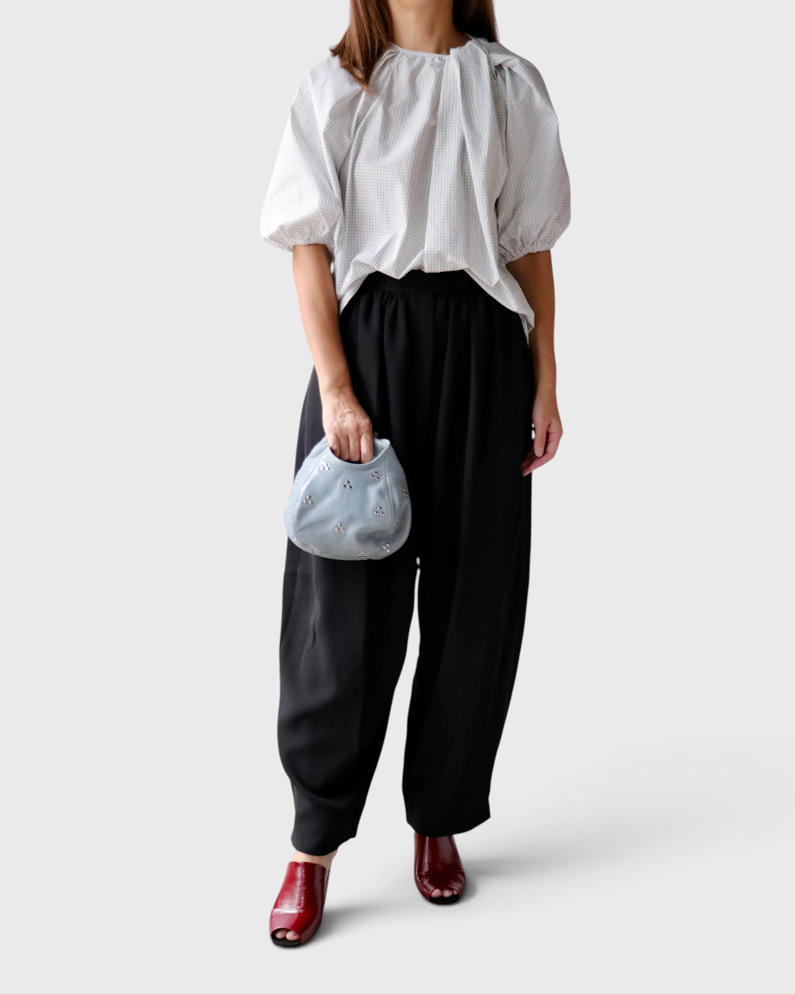JONES + CO Lanson white cotton crewneck top with short bubble sleeves and neck ruching worn with black trousers