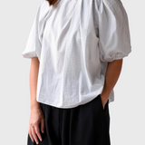 JONES + CO Lanson white crewneck top with short bubble sleeves, ruching at the neck, and a subtle grid pattern.