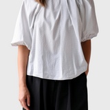 JONES + CO Lanson top in white with a subtle grid pattern, featuring short bubble sleeves and ruched neck detail.