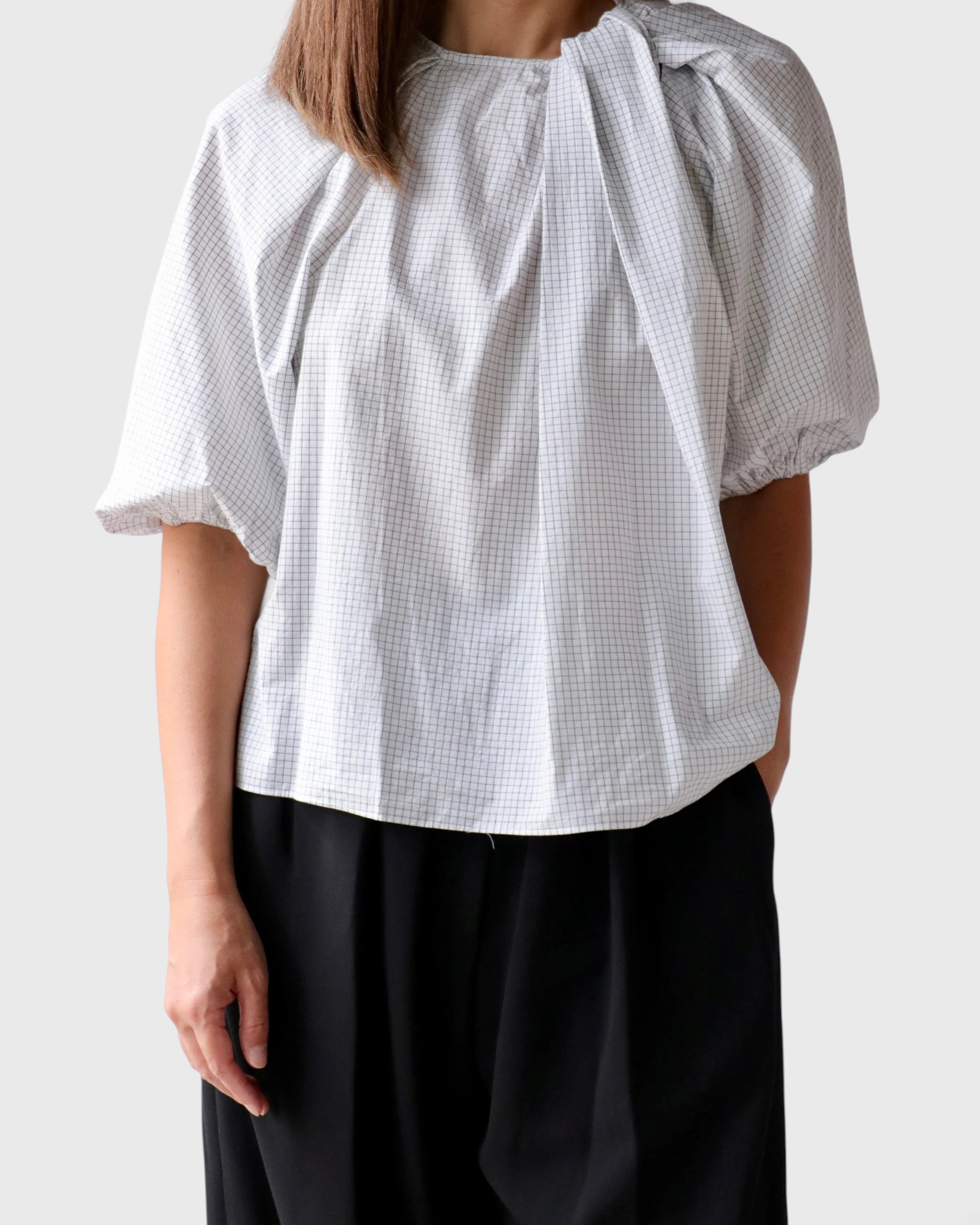 JONES + CO Lanson top in white with a subtle grid pattern, featuring short bubble sleeves and ruched neck detail.