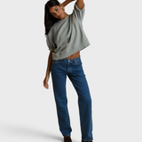 Model wearing JONES + CO Rebecca French terry sweatshirt in griffin grey with three-quarter puff sleeves and blue jeans
