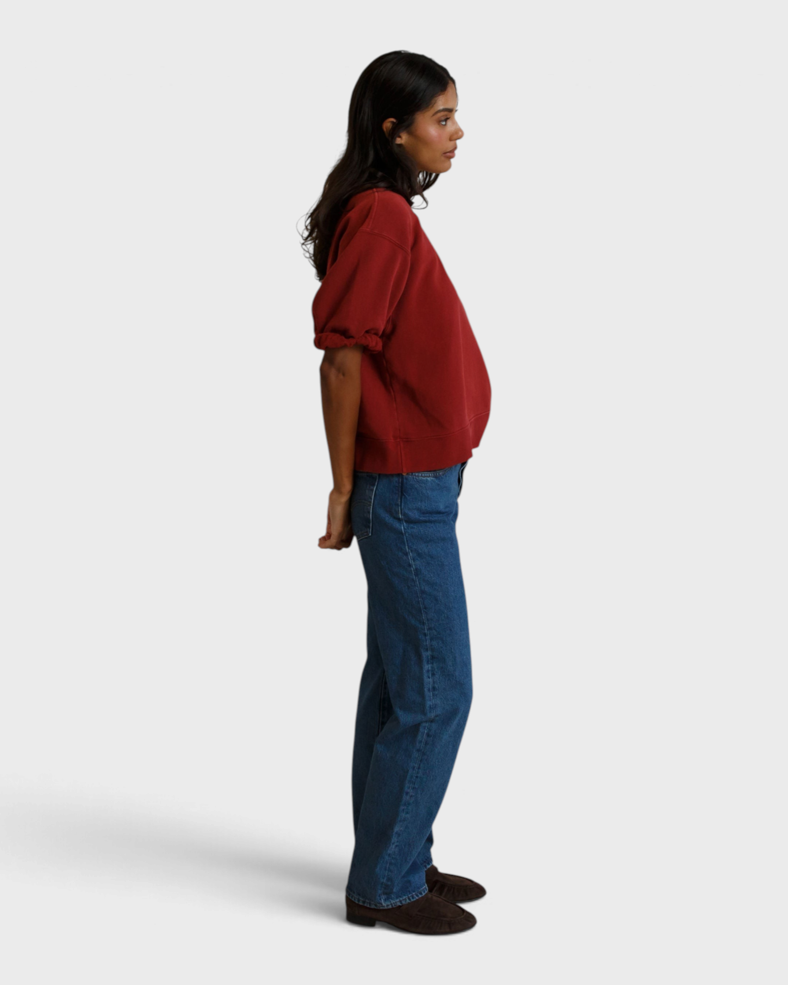 JONES + CO Rebecca French terry sweatshirt in ruby red with three-quarter puff sleeves worn by a model in profile.