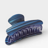 Blue and purple marbled hair clip on a white background