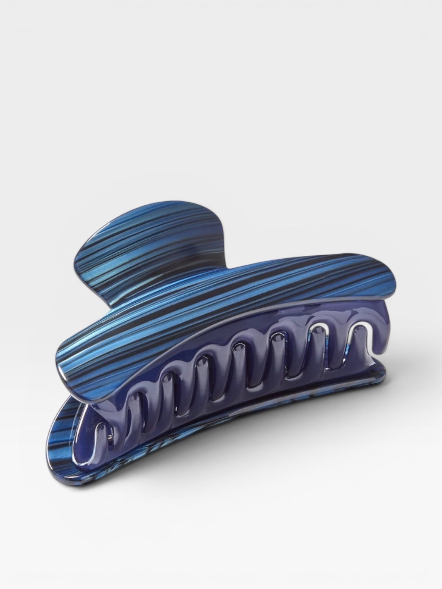 Blue and purple marbled hair clip on a white background