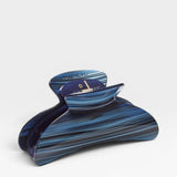 Blue and black striped hair clip on a white background