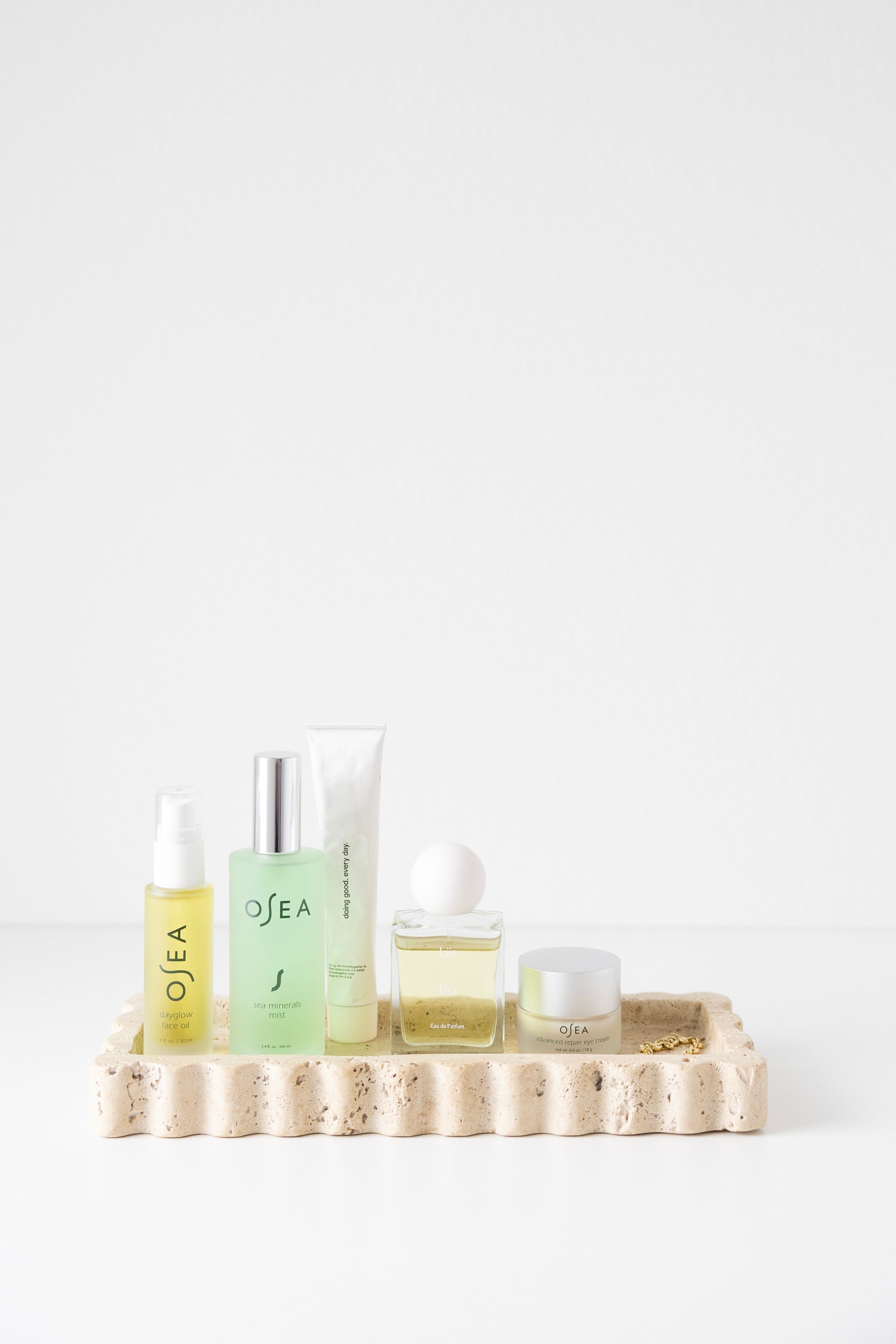 512 Tray - Travertine styled with beauty products on it 