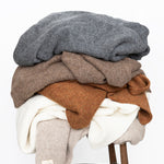 Jones Blankets stacked on stool