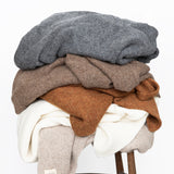 Jones Blankets stacked on stool