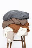 Jones Blankets stacked on stool