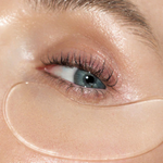 Close-up of a person's eye with a clear gel patch under the eye.
