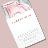 Ametta Skin pink collagen mask in packaging on a light pink background