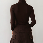 image of back of brown turtleneck on model