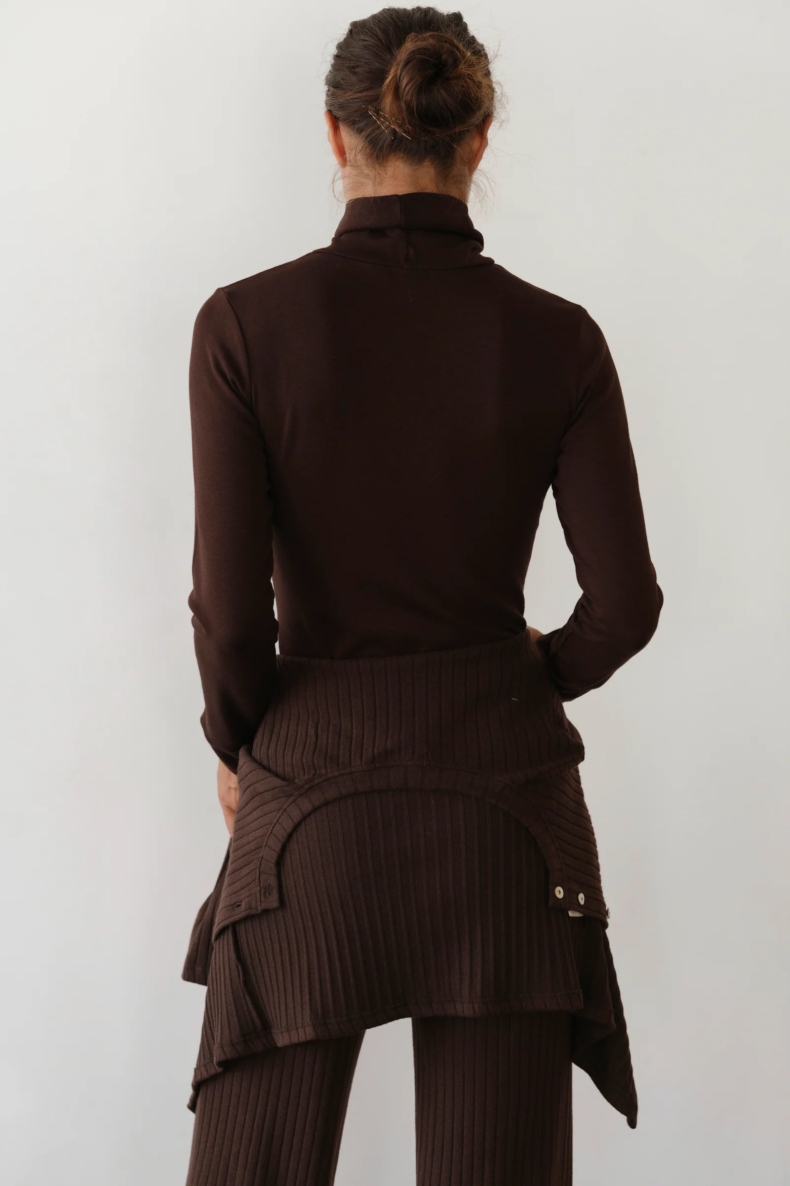 image of back of brown turtleneck on model