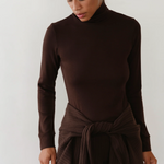 image of brown turtle neck on model with brown pants