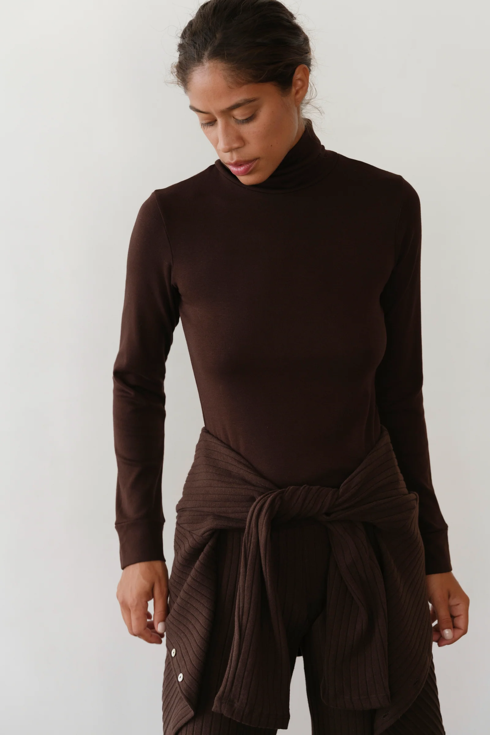 image of brown turtle neck on model with brown pants