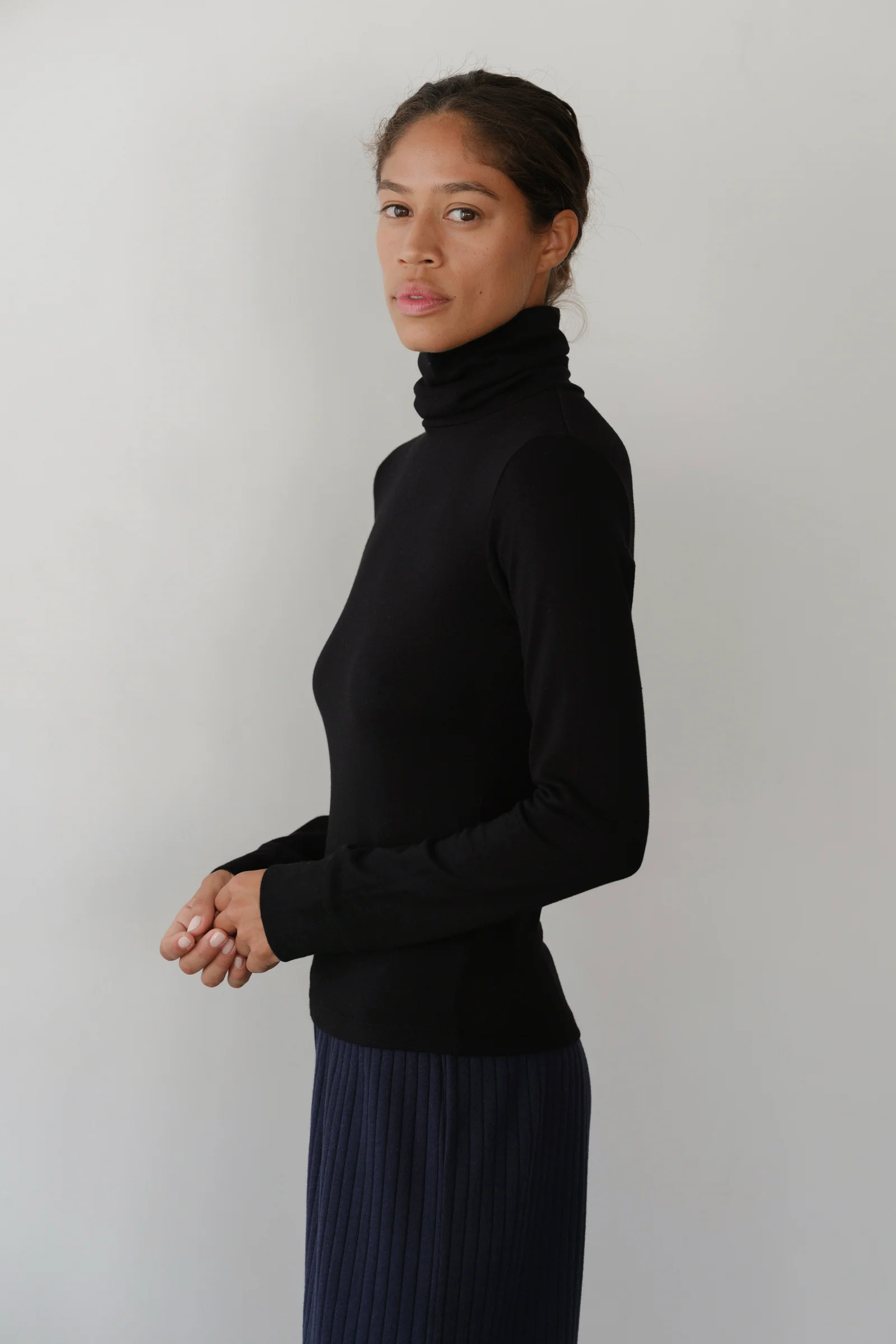 image of side view of model wearing black turtleneck