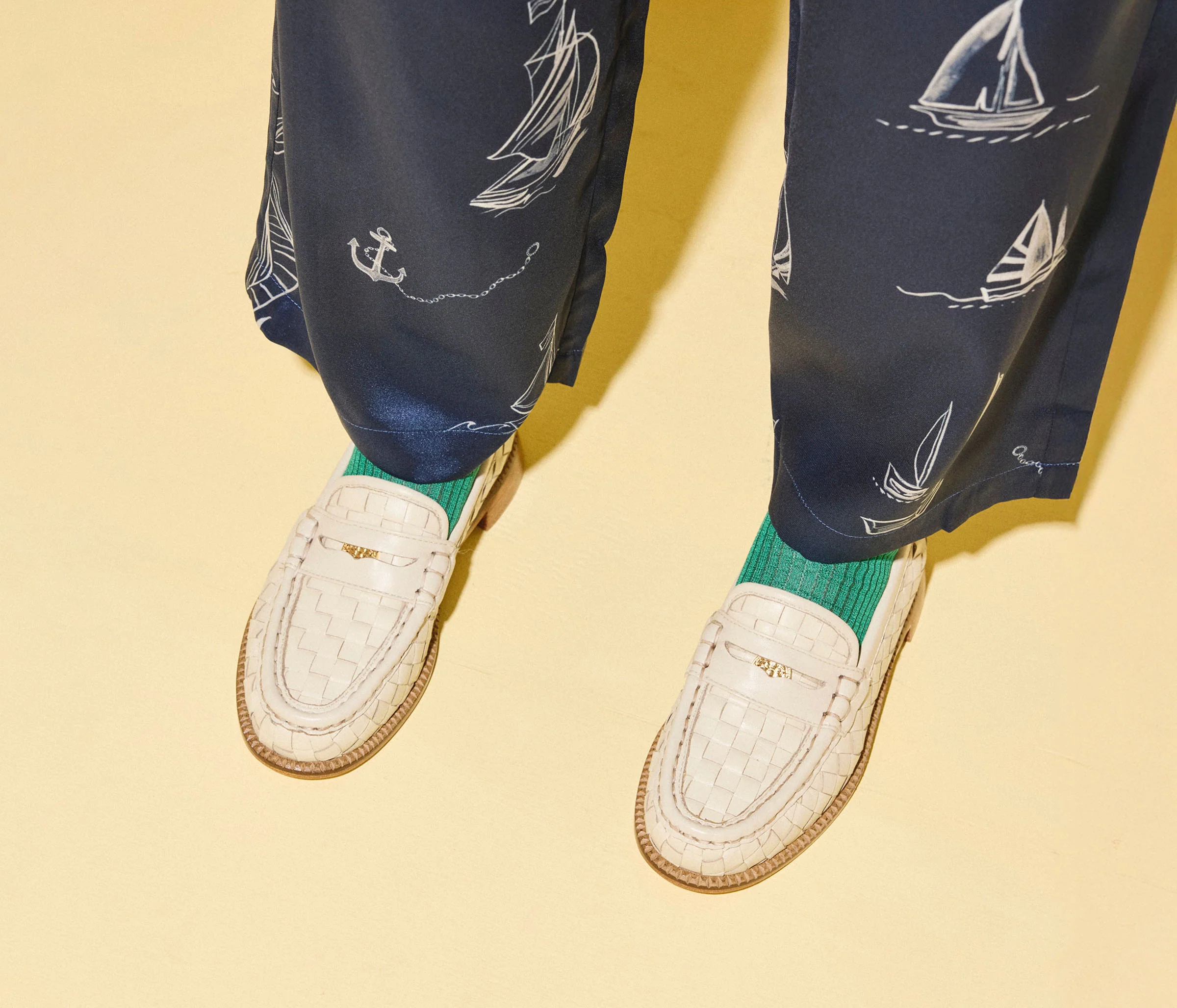 Elba Penny Loafer - Vanilla Woven Calf with Hardware on model, close up view of feet