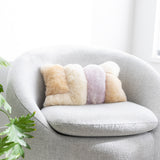 Colorblock fuzzy pillow on a grey round chair