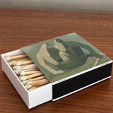 Matchbox with artistic design on a wooden surface