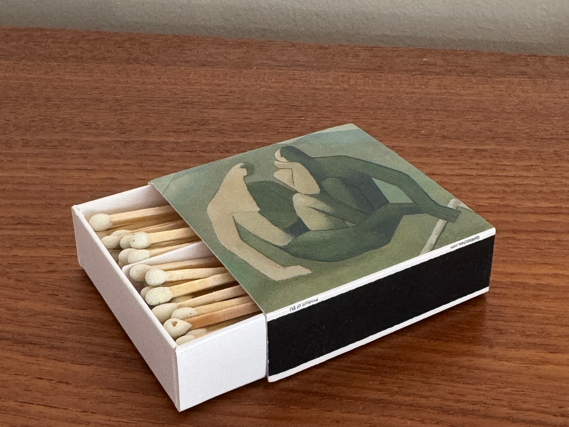 Matchbox with artistic design on a wooden surface