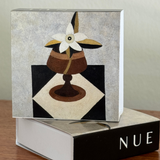 Decorative box with a floral design on a wooden surface