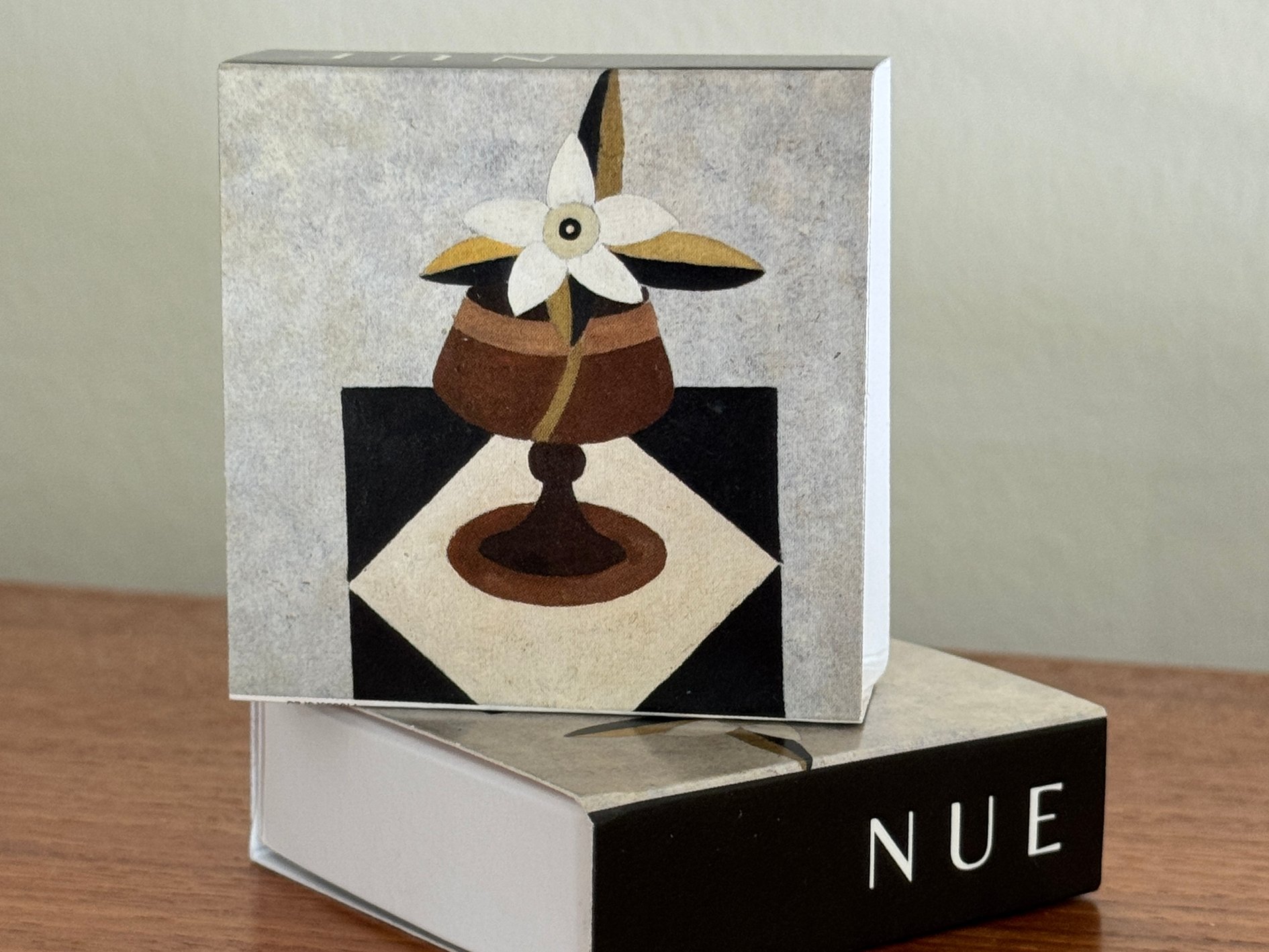 Decorative box with a floral design on a wooden surface