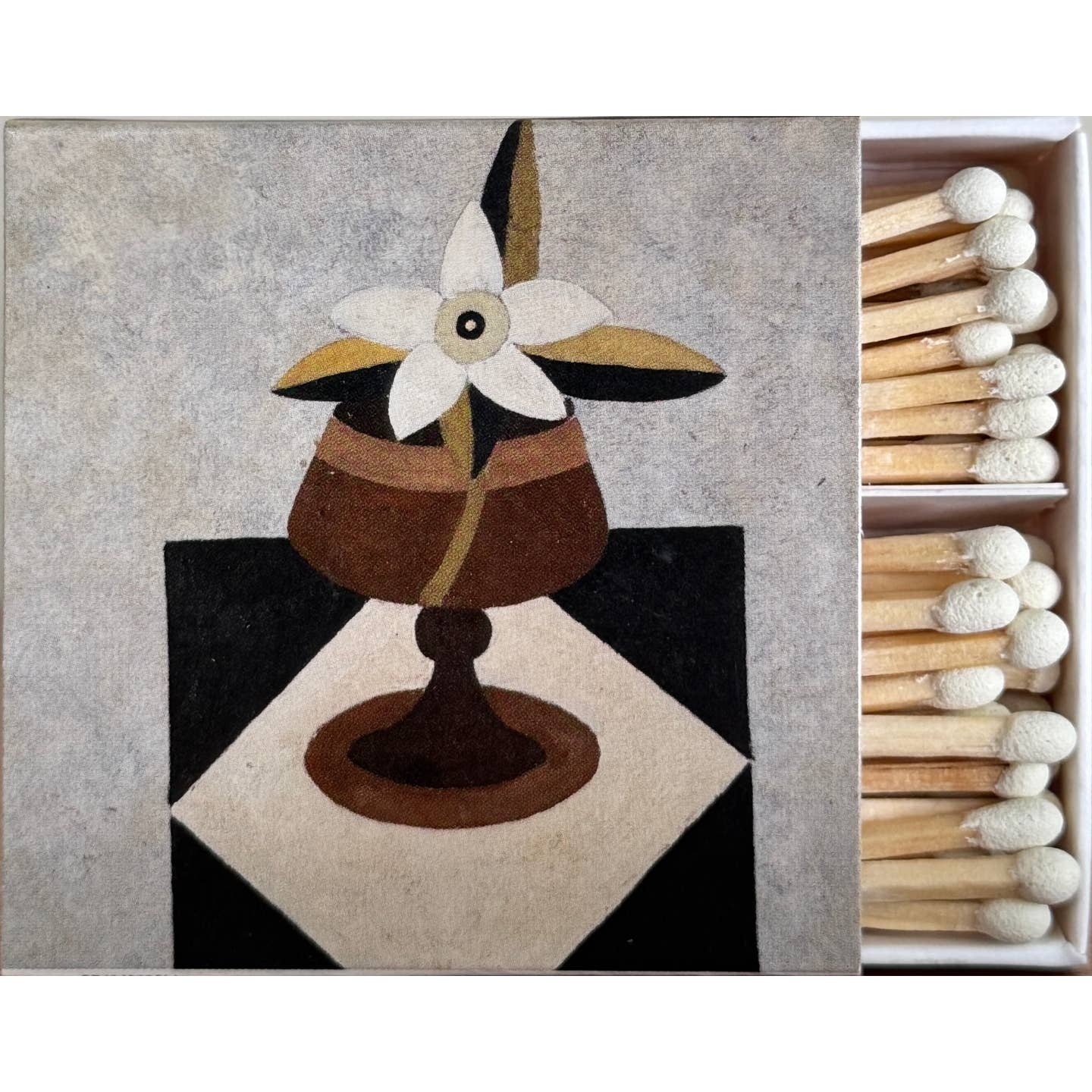 Matches with a decorative matchbox featuring an abstract design of a flower and vase.