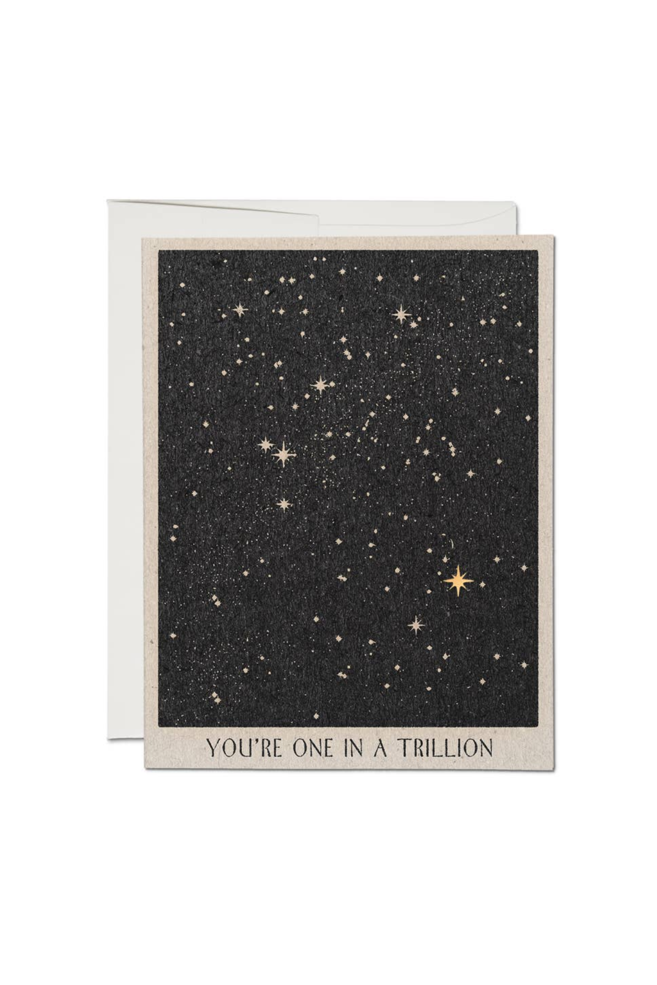 A greeting card with a starry night sky illustration and the text 'YOU'RE ONE IN A TRILLION' on the front.