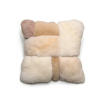 Fur pillow with a woven pattern in beige and brown tones on a white background